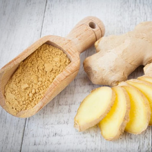Load image into Gallery viewer, Refill Mill: ground ginger on mini wooden scoop next to fresh root ginger and slices on wooden background.
