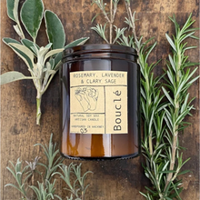 Load image into Gallery viewer, Soy wax aromatherapy candle in amber glass jar surrounded by sprigs of rosemary, lavender and clary sage representing it&#39;s essential oil scent blend.
