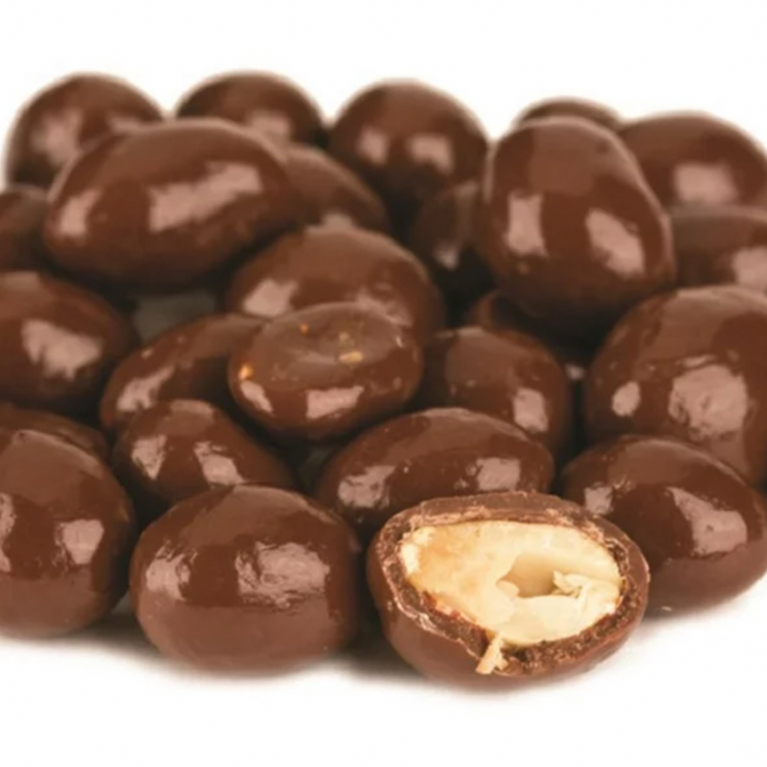 Milk chocolate covered peanuts, one with a bite taken out of it. Refill Mill.