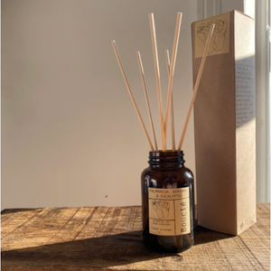 Eco friendly reed diffuser essential oil aromatherapy blend in amber glass jar with rattan reed and kraft gift box