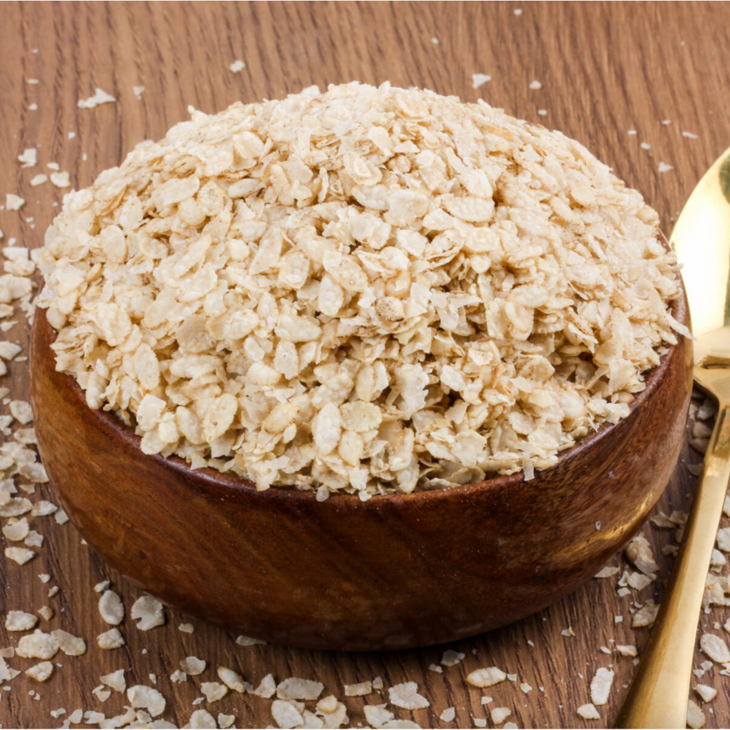 Organic Brown Rice Flakes in wooden bowl - Refill Mill