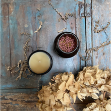Load image into Gallery viewer, Birds eye view of safety matches in amber glass jar next to an unlit soy wax aromatherapy essential oil blend scented candle.
