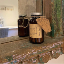Load image into Gallery viewer, Amber glass jar of extra long sustainable safety matches with kraft gift tag on windowsill.
