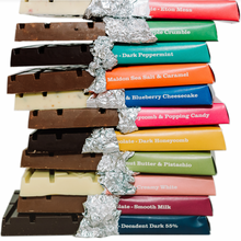 Load image into Gallery viewer, Pile of chunky Temprd chocolate bars with colourful wrapping peeled back to reveal layers of chocolate.

